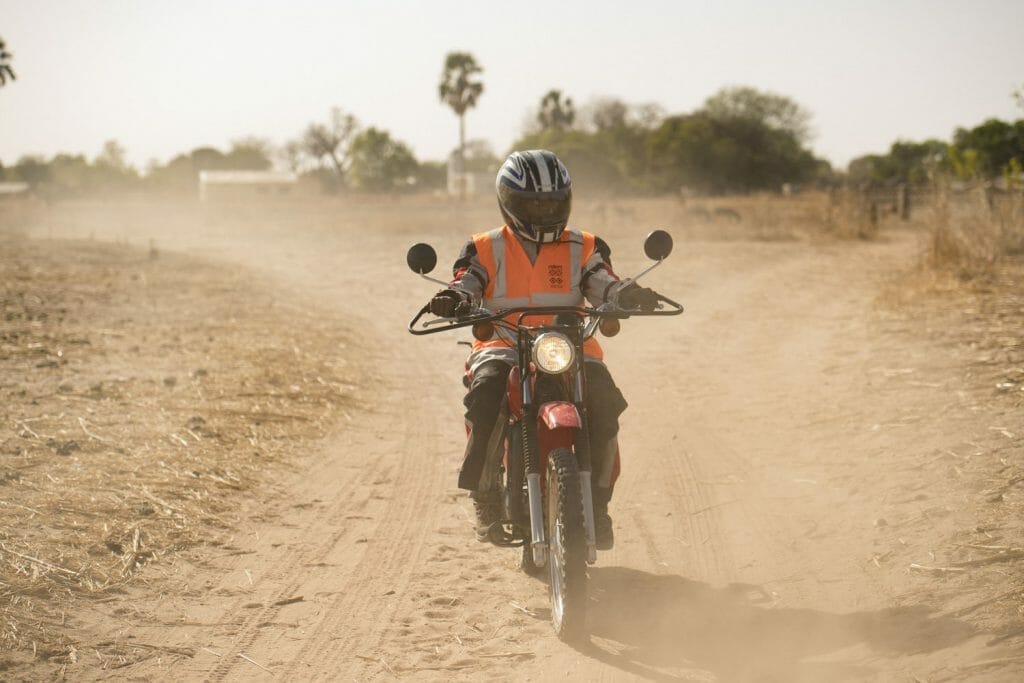 Jogob Gassama - community health worker on motorcycle, The Gambia