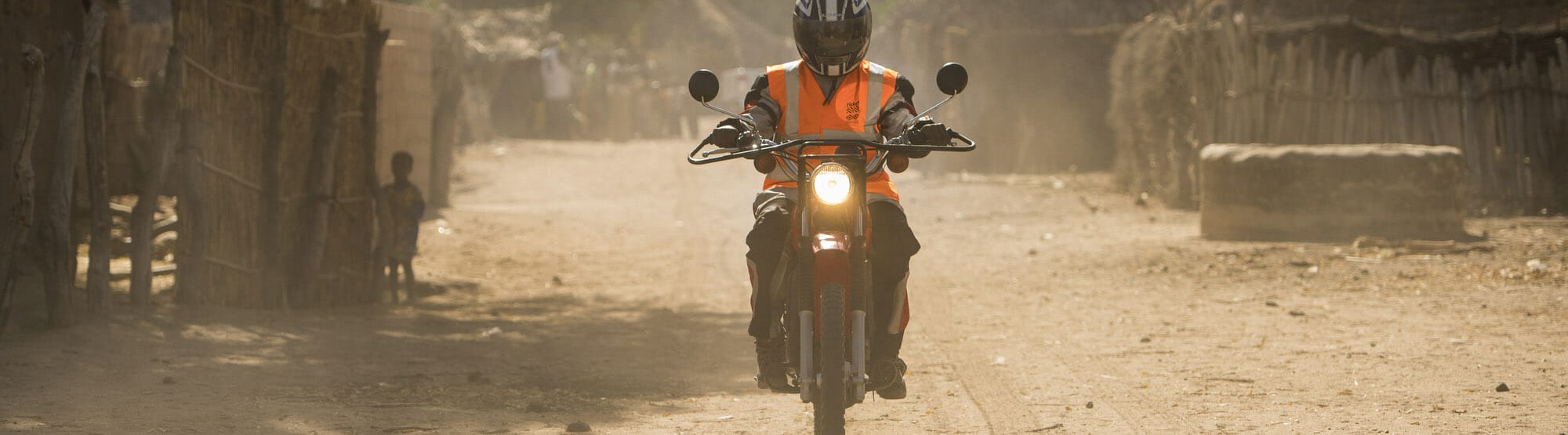 Healthworker riding motorcycle, The Gambia