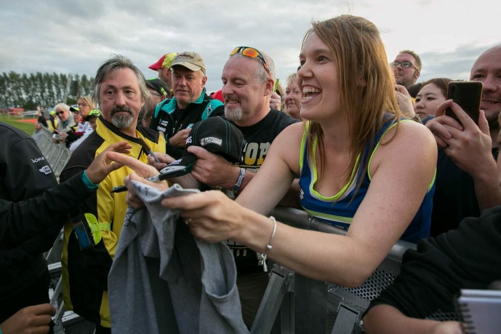 Waiting for riders to sign her shirt