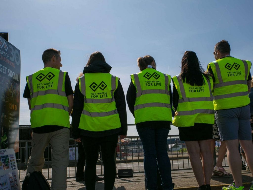 Volunteers showing off their branded bibs