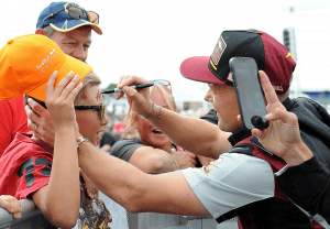 Sam Lowes signs a young fans head